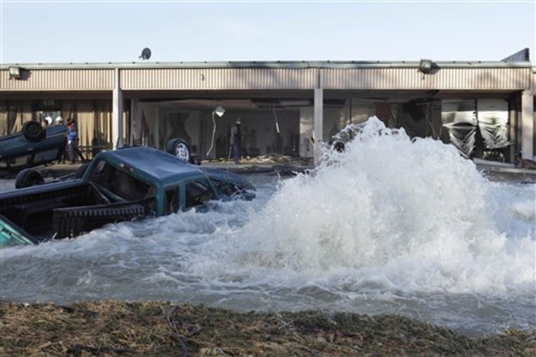 A water main break is seen at an industrial park next to the Capital Beltway in Capitol Heights, Md., Monday, Jan. 24, 2011. The break outside Washington has sent water pouring from a 54-inch pipe, prompting the closure of the inner loop of the Capital Beltway in Maryland and snarling morning traffic. (AP Photo/Jacquelyn Martin)